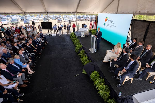 Gov. Brian P. Kemp delivers the May announcement that South Korean automotive giant Hyundai Motor Group is building an electric vehicle plant in Ellabell, Georgia. Kemp has criticized U.S. Sen. Raphael Warnock for backing a climate change measure that Kemp says could undermine the project. (Stephen B. Morton for The Atlanta Journal-Constitution)