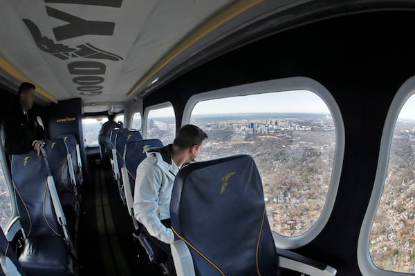 Passengers view the Atlanta skyline through large observation windows in the aircraft during a short flight. Bob Andres / bandres@ajc.com