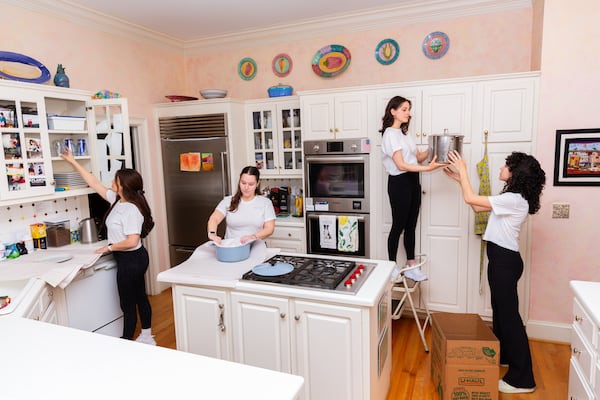 Chan Kavka-Ross and her team at TIDY begin sorting kitchen items, wrapping up keepers.