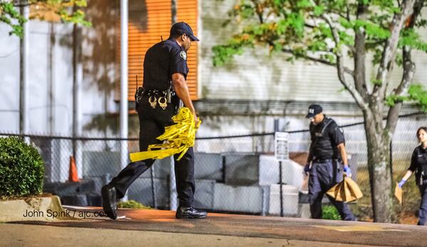 Atlanta police gather evidence at the scene of the Tuesday morning shooting outside Patchwerk Recording Studios. JOHN SPINK / JSPINK@AJC.COM