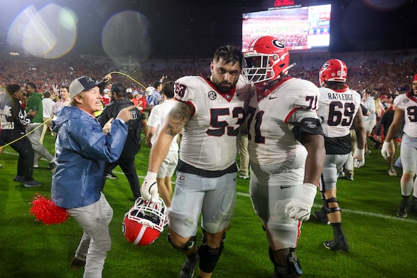 An Ole Miss fan confronts Georgia offensive lineman Dylan Fairchild (center) Earnest Greene III (right center) after the Bulldogs' loss Nov. 9 in Oxford, Miss. Jason Getz/AJC
