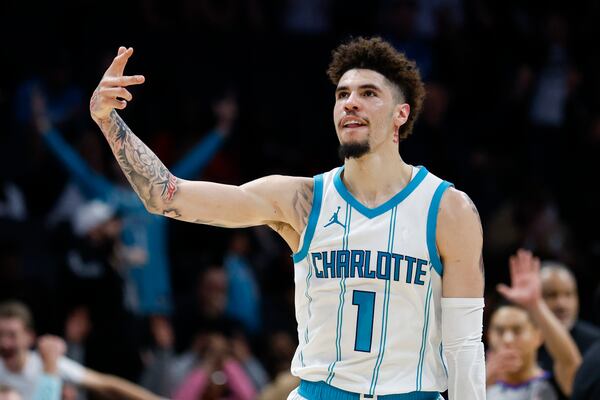 Charlotte Hornets guard LaMelo Ball reacts after making a three point basket against the Miami Heat during the second half of an NBA basketball game in Charlotte, N.C., Wednesday, Nov. 27, 2024. (AP Photo/Nell Redmond)