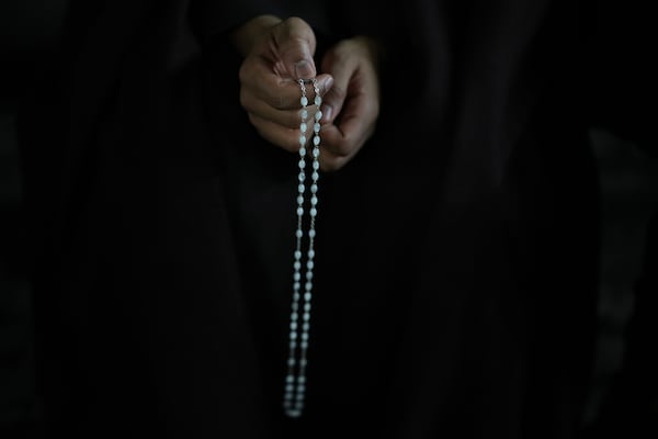 A man holds a rosary beads during a rosary prayer for Pope Francis' health in St. Peter's Square at the Vatican, Tuesday, March 4, 2025. (AP Photo/Alessandra Tarantino)