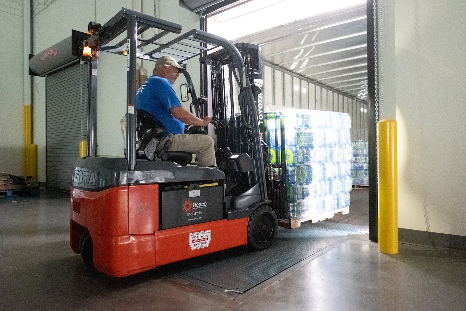 A volunteer at Golden Harvest Food Bank in Augusta hauls a pallet of water headed to area residents impacted by Hurricane Helene.