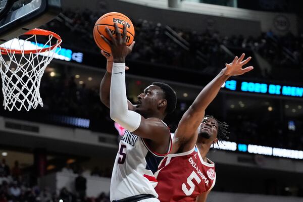 UConn center Tarris Reed Jr., left, scores in front of Oklahoma forward Mohamed Wague, right, during the first half in the first round of the NCAA college basketball tournament, Friday, March 21, 2025, in Raleigh, N.C. (AP Photo/Stephanie Scarbrough)