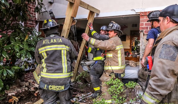 Firefighters support the building after the crash in southwest Atlanta. 