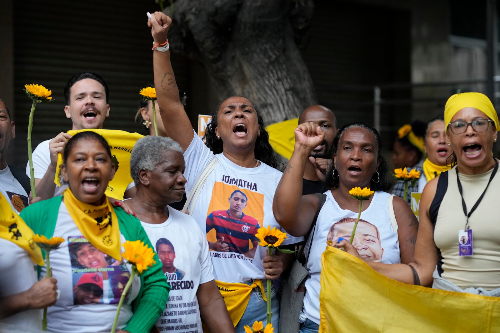 People attend a rally prior to the trial of former Rio de Janeiro city councilwoman Marielle Franco's alleged killers outside the Court of Justice, in Rio de Janeiro, Wednesday, Oct. 30, 2024. (AP Photo/Silvia Izquierdo)