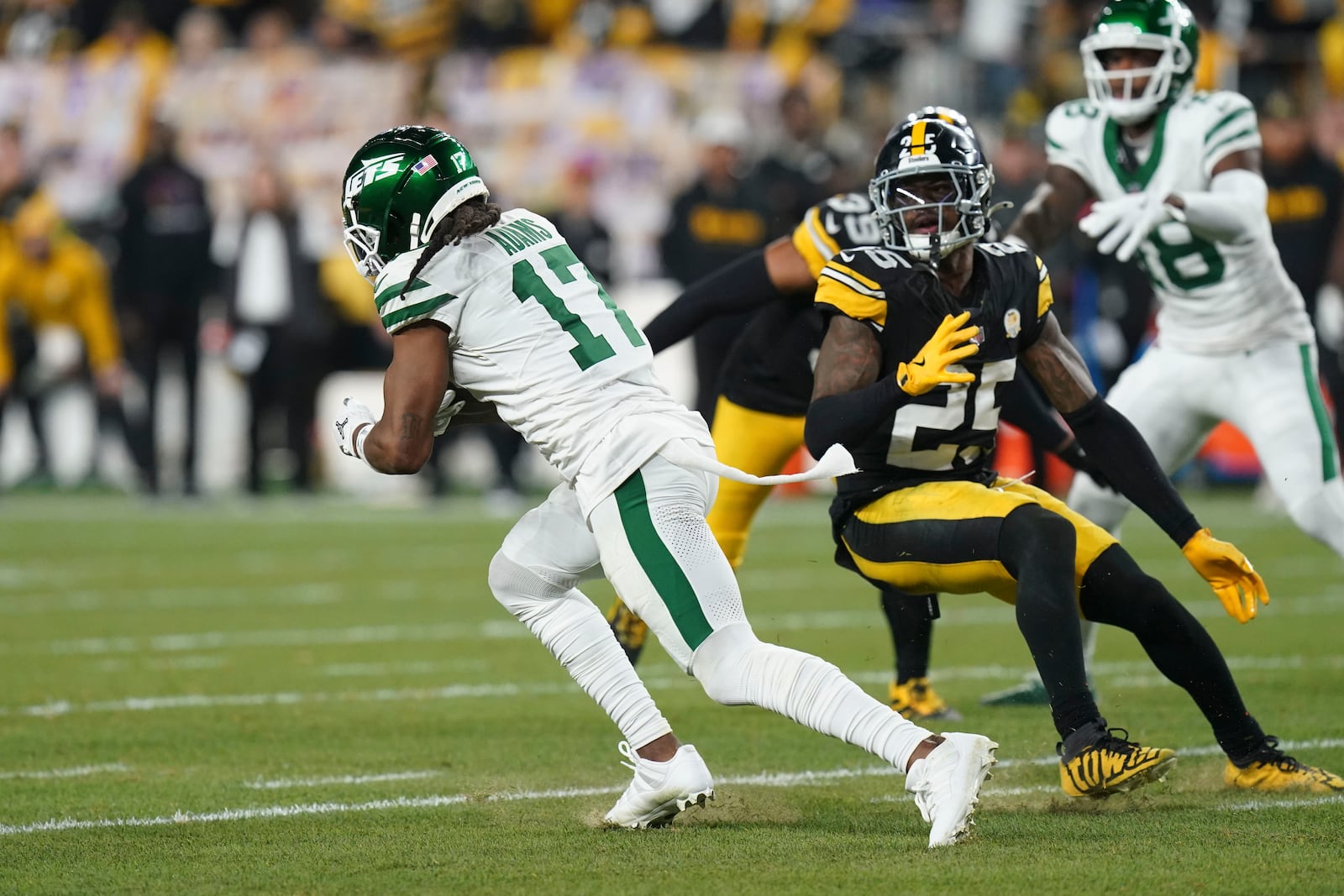 New York Jets wide receiver Davante Adams (17) carries past Pittsburgh Steelers safety DeShon Elliott (25) in the first half of an NFL football game in Pittsburgh, Sunday, Oct. 20, 2024. (AP Photo/Matt Freed)