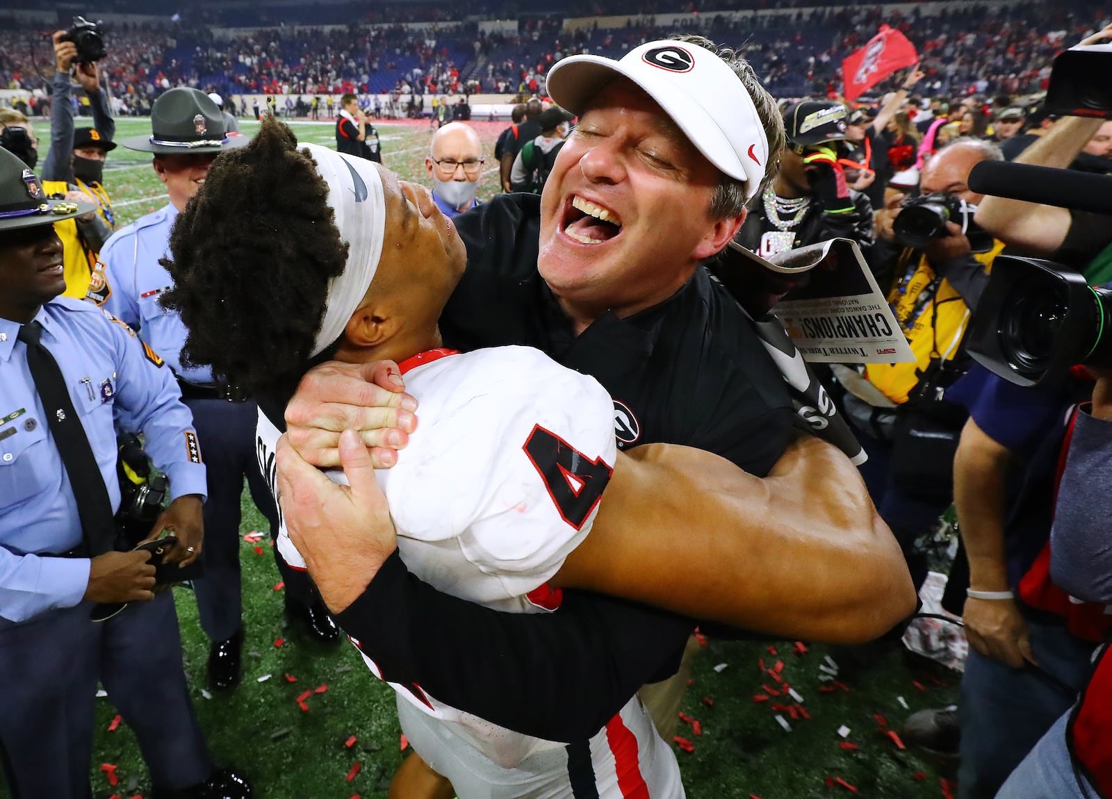 011022 Indianapolis: Georgia head coach Kirby Smart celebrates winning the College Football Playoff Championship game against Alabama getting a hoist from outside linebacker Bolan Smith on Monday, Jan. 10, 2022, in Indianapolis.  “Curtis Compton / Curtis.Compton@ajc.com”`