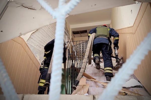 In this photo provided by the Ukrainian Emergency Service, firefighters work on the site of a damaged building after a Russian missile hit the area, in Kryvyi Rih, Ukraine, Wednesday, March 12, 2025. (Ukrainian Emergency Service via AP)