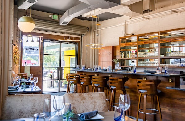 Oreatha's interior has calming gray-blue and white brick walls, and the restaurant also boasts a breezy patio. Ryan Fleisher for The Atlanta Journal-Constitution