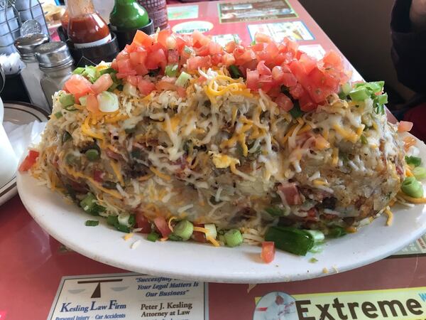 To fuel up before tramping around the Hoh rainforest on the Olympic Peninsula, Ligaya Figueras and her family stopped at Marcia’s Silver Spoon Cafe, an old-school diner in Tacoma. Pictured is the Silver Spoon Scramble, a massive mound of hash browns mixed with scrambled eggs, diced ham, onions, bell peppers, tomatoes and shredded cheese. LIGAYA FIGUERAS/LFIGUERAS@AJC.COM