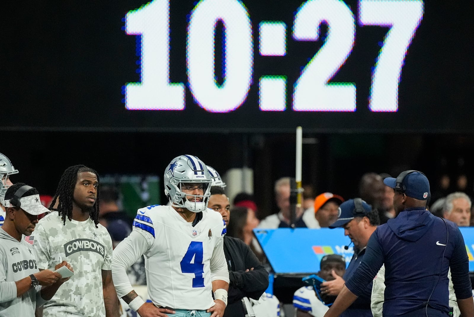 Dallas Cowboys quarterback Dak Prescott (4) watches from the sideline during the second half of an NFL football game against the Atlanta Falcons, Sunday, Nov. 3, 2024, in Atlanta. (AP Photo/ John Bazemore)