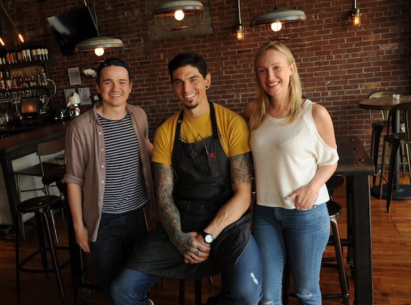 Chef Justin Balmes (center), Dan Byrd (left) and Lauren Smith (right) at Two Birds Taphouse in Marietta. (BECKY STEIN PHOTOGRAPHY)