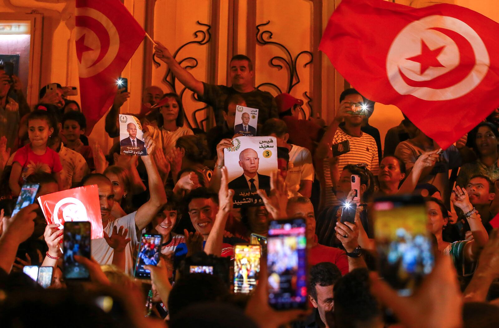 Supporters of Tunisian president and candidate for re-election Kais Saied celebrate after the announcement of the provisional results for the presidential elections, in the capital Tunis, Tunisia, Sunday, Oct. 6, 2024. (AP Photo/Anis Mili)