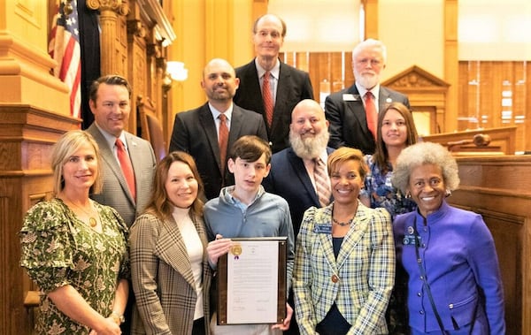 Brookstone School eighth-grader Collin Etheridge and staff were recognized Feb. 23, 2023, by the Georgia Legislature. The Brookstone contingent came to the State Capitol in Atlanta to advocate for more CPR and AED training in schools. Pictured are, from left: front row, Brookstone nurse Linda Sheffield, Meghann Etheridge, Collin Etheridge, state Sen. Sonya Halpern and state Sen. Valencia Seay; second row, Lt. Gov. Burt Jones, Brookstone faculty member Nate McConnell, Muscogee County sheriff’s deputy Jonnie Ellerbee and Brookstone faculty member Lucy Pound; back row, Brookstone head of school Marty Lester and state Sen. Randy Robertson. (Photo provided by Connie Mansour/Brookstone School)