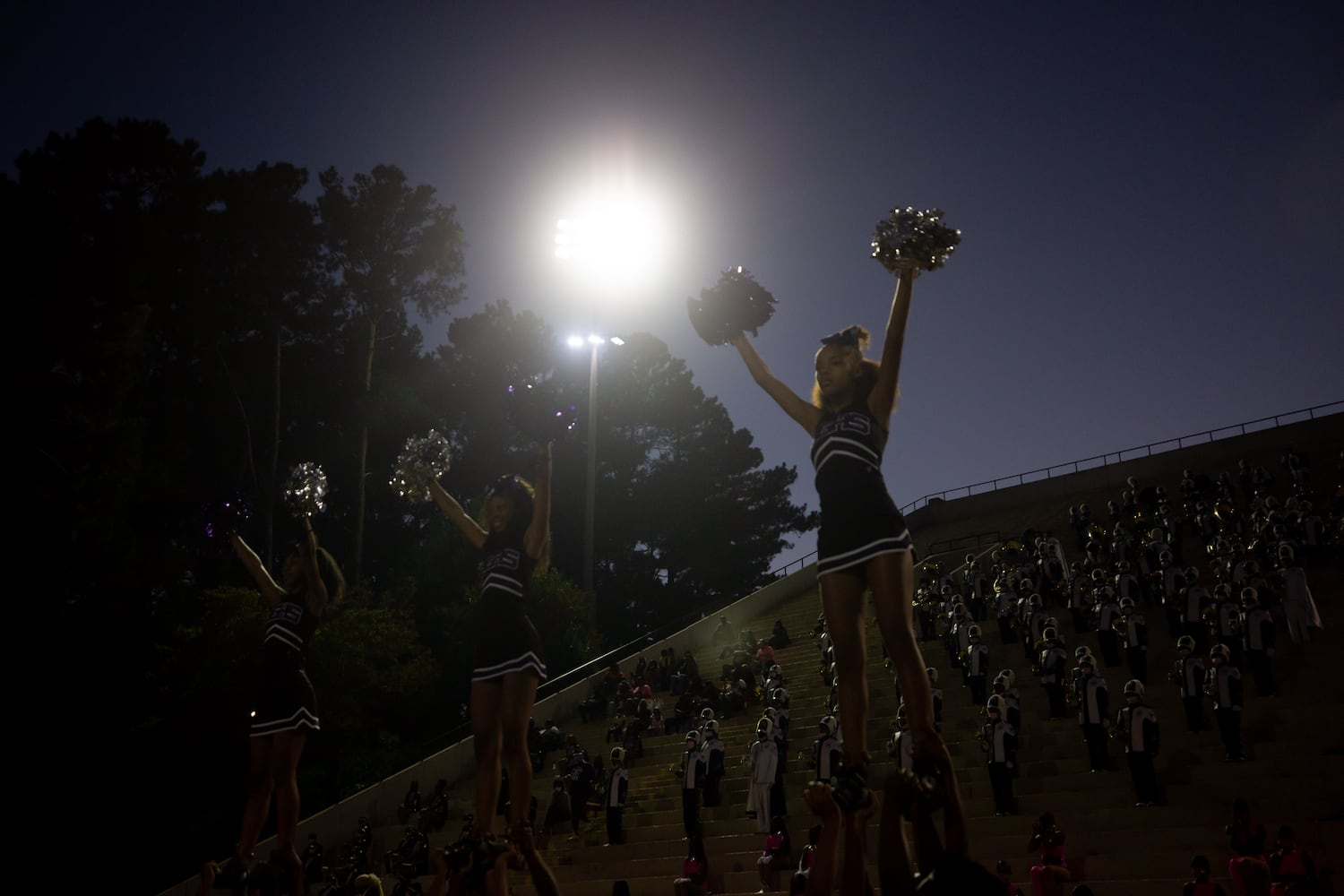 Cheerleaders raise their pom poms during a GHSA high school football game between Stephenson High School and Miller Grove High School at James R. Hallford Stadium in Clarkston, GA., on Friday, Oct. 8, 2021. (Photo/Jenn Finch)