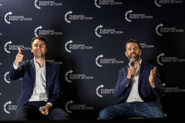 Charlie Kirk, left and Donald Trump Jr., take part in a town hall meeting Monday, March 17, 2025, in Oconomowoc, Wis. (AP Photo/Jeffrey Phelps)