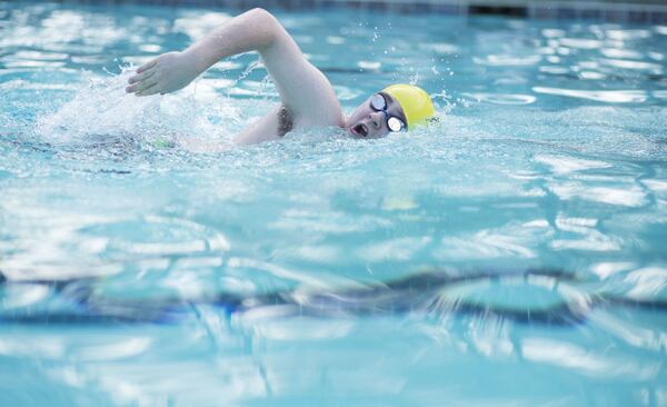 After working on biking and running, Matthew McMahon perfects his freestyle stroke in his neighborhood pool to prepare for a triathlon this August. McMahon takes off his prosthetic leg before engaging in the aquatic sport. On June 25, McMahon, who competed in his first post-cancer diagnosis triathlon last August, will serve as emcee for the seventh annual PT Solutions Allatoona Triathlon. Proceeds will benefit the Rally Foundation for Childhood Cancer Research. CHAD RHYM/ CHAD.RHYM@AJC.COM