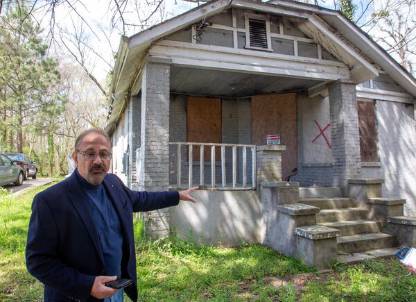 The house Kumar owns now has a red X spray-painted on it. STEVE SCHAEFER FOR THE ATLANTA JOURNAL-CONSTITUTION