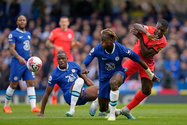 Chelsea's Trevoh Chalobah, centre, is challenged by Brighton's Moises Caicedo during the English Premier League soccer match between Chelsea and Brighton and Hove Albion at Stamford Bridge stadium in London, Saturday, April 15, 2023. (AP Photo/Kirsty Wigglesworth)