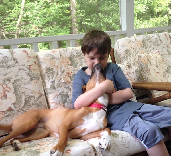 In this file photo, best friends Jonny Hickey and his dog Xena share a snuggle on the couch.