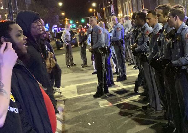 Demonstrators come face to face with police at an intersection during a protest Wednesday, March 11, 2020, in Raleigh, North Carolina. Raleigh Police said in a statement that an officer shot a man after a foot chase on Tuesday. (Courtesy of Kerwin Pittman via AP)