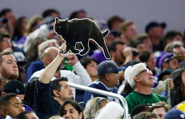 A Dallas Cowboys fan holds up a cutout of a black cat in the stands during the second half against the Minnesota Vikings on Sunday, Nov. 10, 2019 at AT&T Stadium in Arlington, Texas.