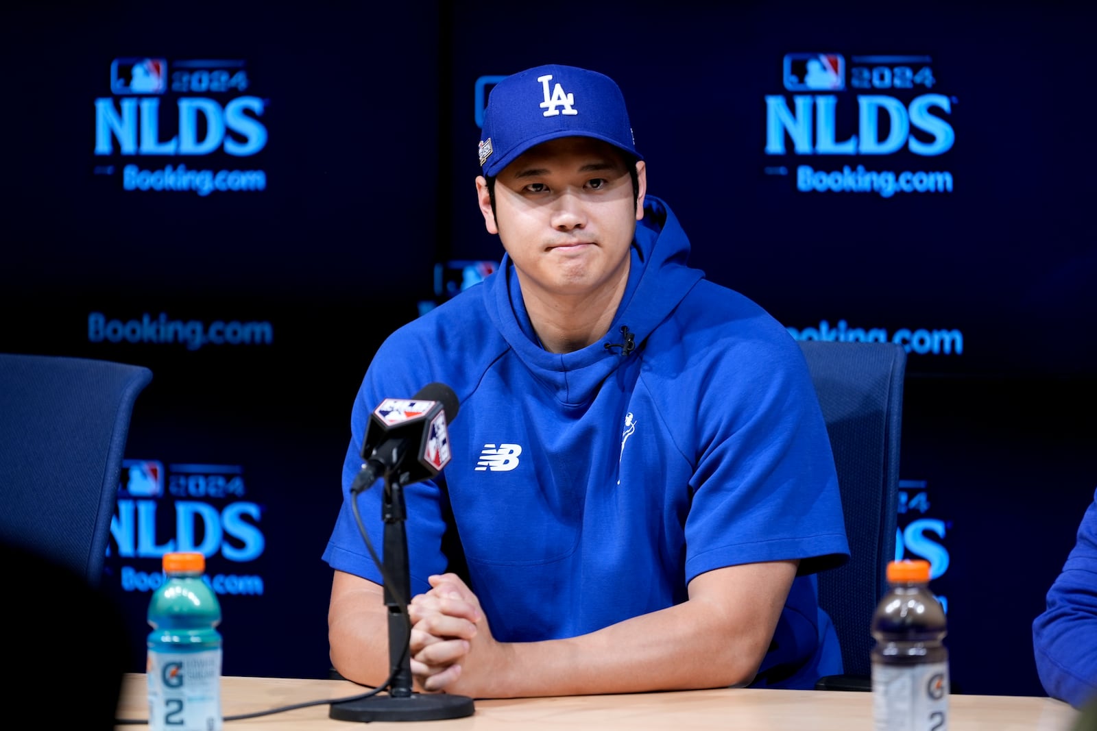 Los Angeles Dodgers' Shohei Ohtani fields questions ahead of Game 5 of a baseball National League Division Series against the San Diego Padres, Thursday, Oct. 10, 2024, in Los Angeles. (AP Photo/Ashley Landis)