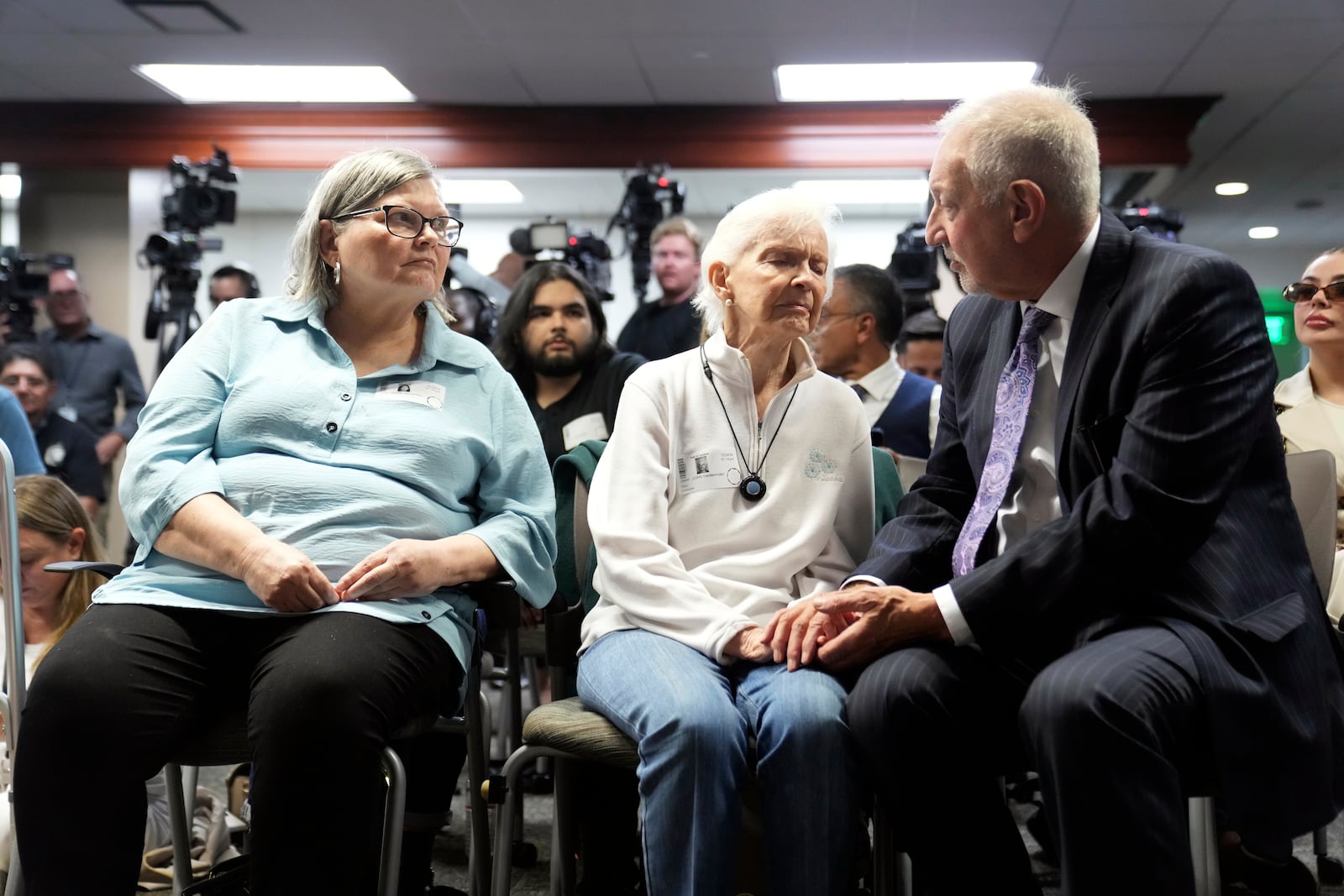 FILE - Kitty Menendez's sister, Joan Andersen VanderMolen, center, is greeted by Defense Attorney Mark Geragos as Diane Hernandez, niece of Kitty Menendez, left, looks on, prior to a news conference being held by Los Angeles County District Attorney George Gascon at the Hall of Justice, Oct. 24, 2024, in Los Angeles. (AP Photo/Eric Thayer, File)