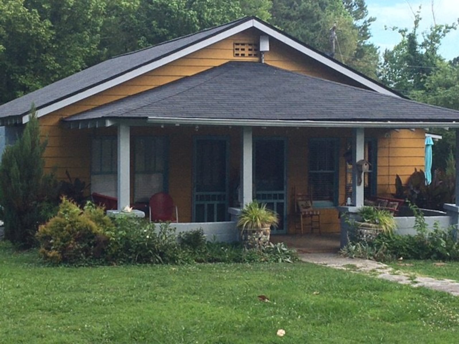 The yellow cottage with Suite #1 (left) and Suite #2 across the road from Paradise Garden. Available on AirBnb, a stay in the suites gives visitors 24/7 access to walk the grounds of folk artist Howard Finster's amazing four-acre creation. (BILL RANKIN/william.rankin@ajc.com)