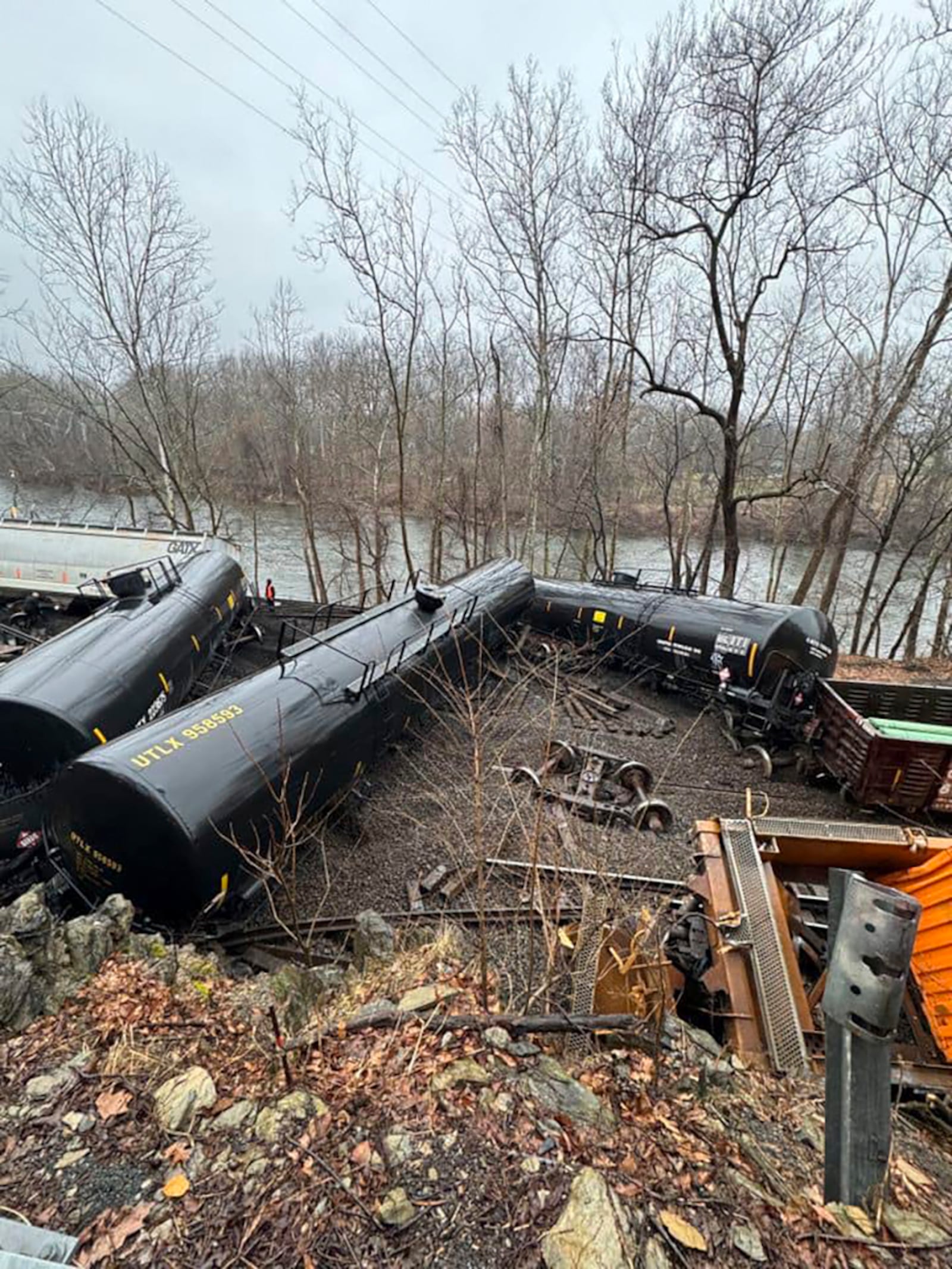 This photo provided by Nancy Run Fire Company shows a train derailment along a riverbank in Saucon Township, Pa., on Saturday, March 2, 2024.   Authorities said it was unclear how many cars were involved but no injuries or hazardous materials were reported.   (Nancy Run Fire Company via AP)