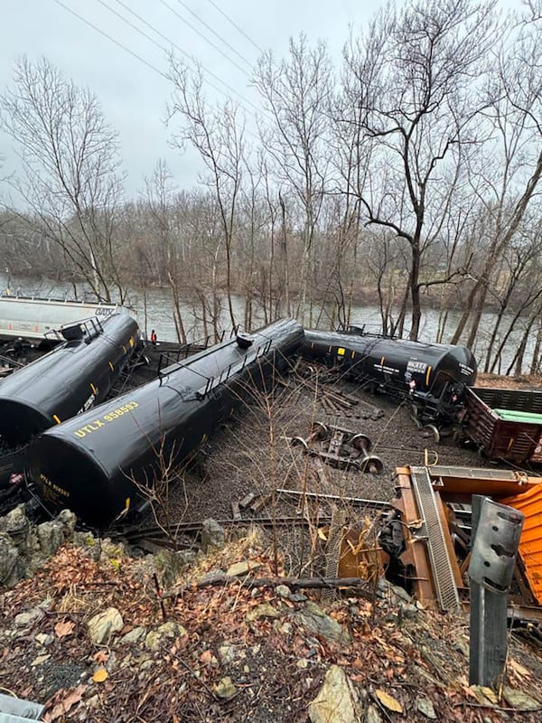 This photo provided by Nancy Run Fire Company shows a train derailment along a riverbank in Saucon Township, Pa., on Saturday, March 2, 2024.   Authorities said it was unclear how many cars were involved but no injuries or hazardous materials were reported.   (Nancy Run Fire Company via AP)