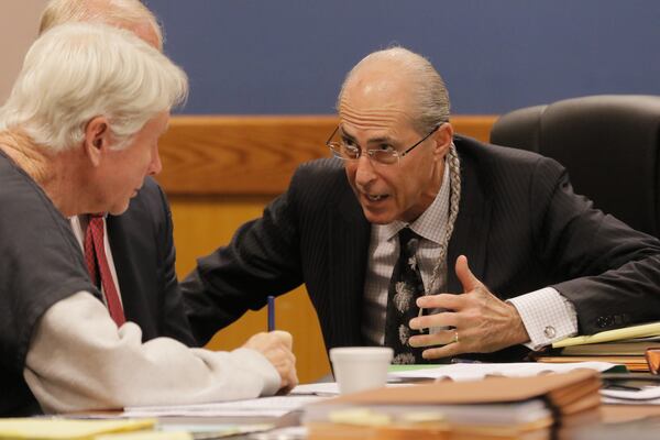 Tex McIver confers with attorney Bruce Harvey during a hearing in September in Fulton County Superior Court. Bob Andres / bandres@ajc.com