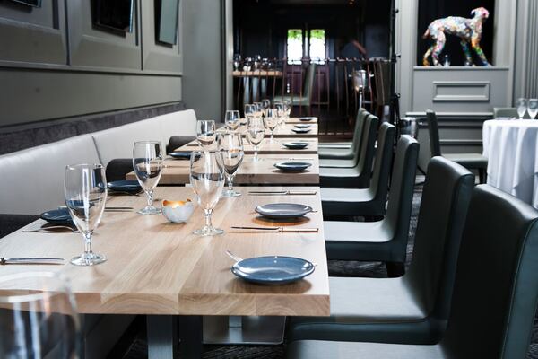 The updated dining room at Aria includes includes new leather banquettes and white oak tabletops. Credit: LuAnne DeMeo