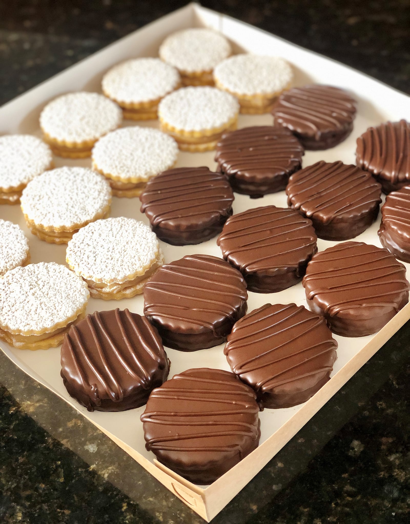 Alfajores are butter sandwich cookies filled with dulce de leche. Pastil Artisan Bakery sells a classic version, as well as one coated in chocolate. Courtesy of Nicole Benza