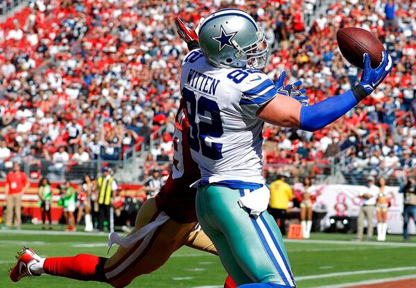 FILE - In this Oct. 22, 2017, file photo, Dallas Cowboys tight end Jason Witten (82) catches a touchdown in front of San Francisco 49ers strong safety Jaquiski Tartt during the first half of an NFL football game in Santa Clara, Calif. A person with direct knowledge of the decision says Jason Witten is retiring after 15 seasons, choosing the offer of lead analyst for ESPNâs âMonday Night Footballâ over becoming the longest-tenured player in the history of the Dallas Cowboys. The 10-time Pro Bowl tight end informed Cowboys owner Jerry Jones of his plan to retire Thursday, May 3, 2018, according to the person who spoke on condition of anonymity because the decision hasnât been announced.  (AP Photo/Marcio Jose Sanchez, File)