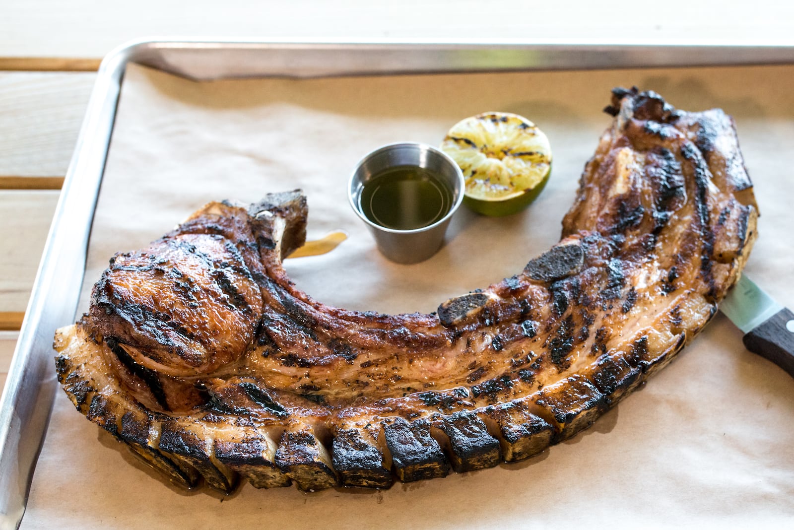 Puerto Rican fried pork chop “Can Can" at Porch Light Latin Kitchen. Photo Credit- Mia Yakel. Styling Credit- Chef Andre Gomez