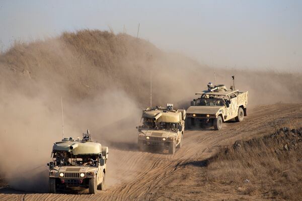 FILE - Israeli soldiers drive military vehicles during an exercise in the Israeli controlled Golan Heights near the border with Syria, Tuesday, Aug. 4, 2020. (AP Photo/Ariel Schalit, File)