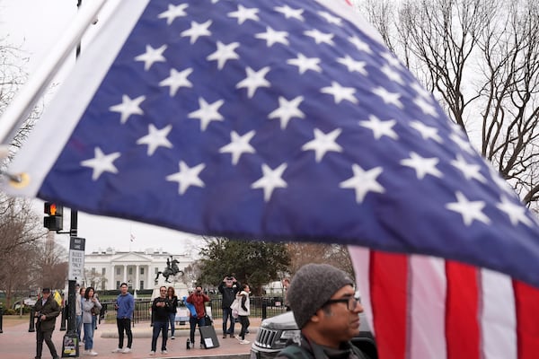 Doris Coulter of Columbus, Ohio, protests against the Trump administration near the White House Friday, March 14, 2025, in Washington. (AP Photo/Jacquelyn Martin)