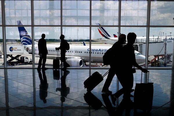 File photo of passengers walk through the International Terminal at Hartsfield-Jackson Atlanta International Airport. COVID cases are on the rise as we head into Christmas. 
Miguel Martinez / miguel.martinezjimenez@ajc.comMiguel 