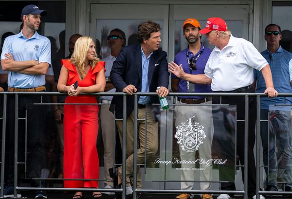  Eric Trump, Rep. Marjorie Taylor Greene (R-Ga.), Tucker Carlson, Donald Trump Jr. and former President Donald Trump at Trump National Golf Club in Bedminster, N.J., July 31, 2022. Carlson recently aired video footage of the Jan. 6, 2021 attack on the U.S. Capitol. (Doug Mills/The New York Times)