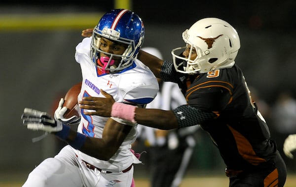 Marietta, Ga. -- Kell junior defensive back Michael McCain (9) makes a tackle on Riverwood running back Marvin Kinsey (5) late in the second half of play at Kell High Friday, October 16, 2015. Special/Daniel Varnado