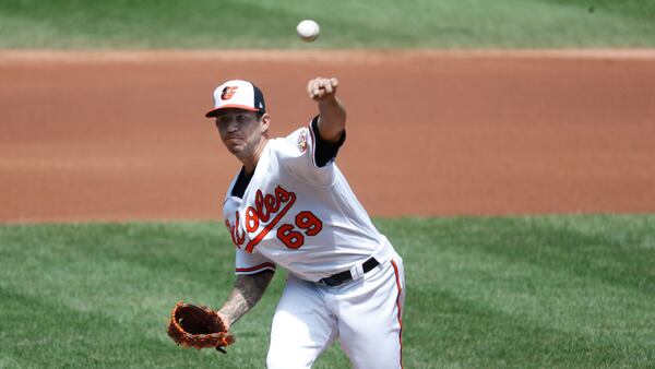 Baltimore Orioles' starting pitcher Tommy Milone (69) pitches against the Toronto Blue Jays during the first inning of a baseball game, Wednesday, Aug. 19, 2020, in Baltimore. (AP Photo/Michael Owens)