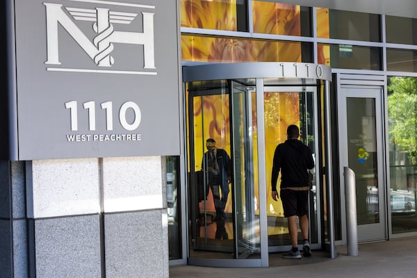 A person walks into a Northside Hospital medical building in Midtown Atlanta on Thursday, May 4, 2023, where the previous day a gunman killed one person and injured four more. (Arvin Temkar / arvin.temkar@ajc.com)