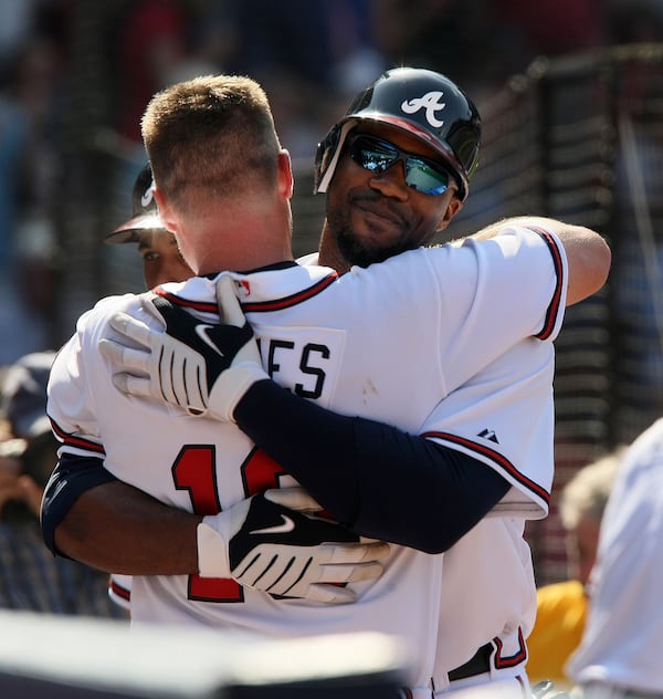 Opening Day 2010: Chipper Jones  hugs Jason Heyward after Heyward hit a home run in his first big-league regular-season at-bat. 