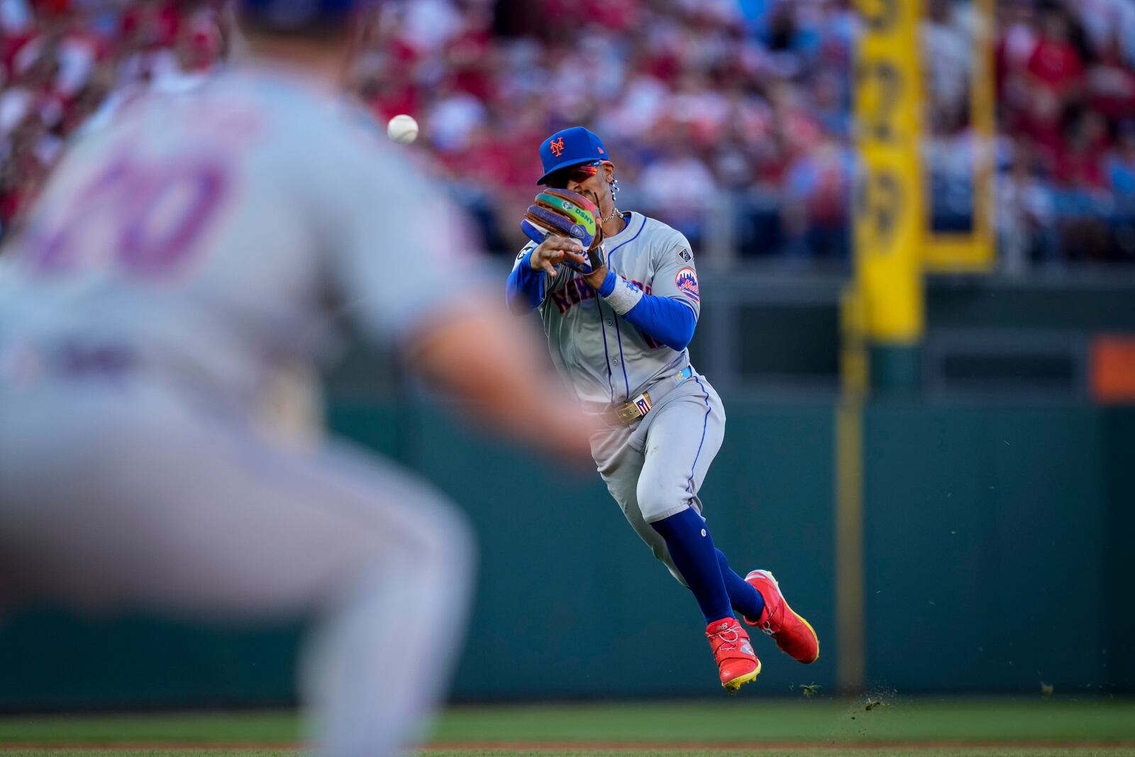 New York Mets shortstop Francisco Lindor throws to first on a ground out by Philadelphia Phillies' Johan Rojas during the third inning of Game 1 of a baseball NL Division Series, Saturday, Oct. 5, 2024, in Philadelphia. (AP Photo/Matt Slocum)