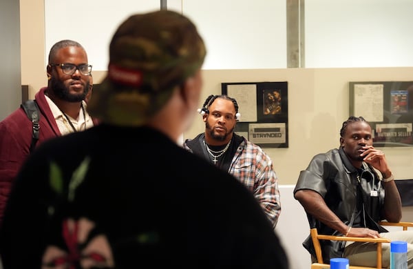 Former and current NFL players, from left, Reginald Kahlil McKenzie, Dion Dawkins and Tevaughn Campbell listen to filmmaker and former professional basketball player Deon Taylor, foreground, discuss the movie industry during a filmmaking workshop for NFL players on Tuesday, March 4, 2025, in Santa Monica, Calif. (AP Photo/Chris Pizzello)