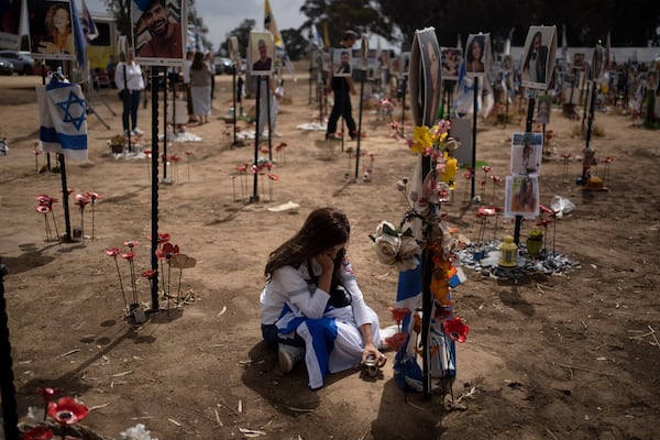 FILE - A woman grieves at a memorial for those killed and abducted during the Oct. 7, 2023, cross-border attack by Hamas militants, near the kibbutz Reim, southern Israel, May 13, 2024. (AP Photo/Leo Correa, File)