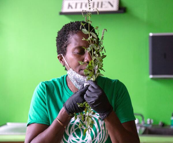 Owner of Iwi Fresh Farm-to-Skin Spa Yolanda Owens smells some of the herbs she uses to make her hydration face mist at her Atlanta spa Wednesday, July 01, 2020. STEVE SCHAEFER FOR THE ATLANTA JOURNAL-CONSTITUTION